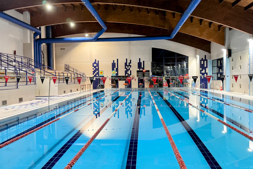 An indoor swimming pool with marked lanes