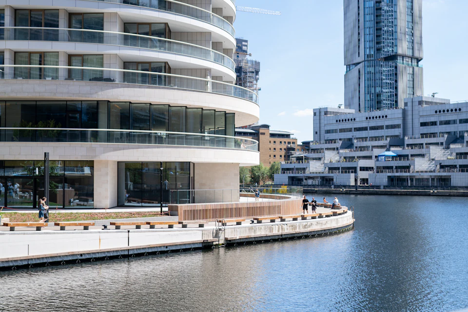 A curved waterfront and apartment buildings beside a dock in London Docklands