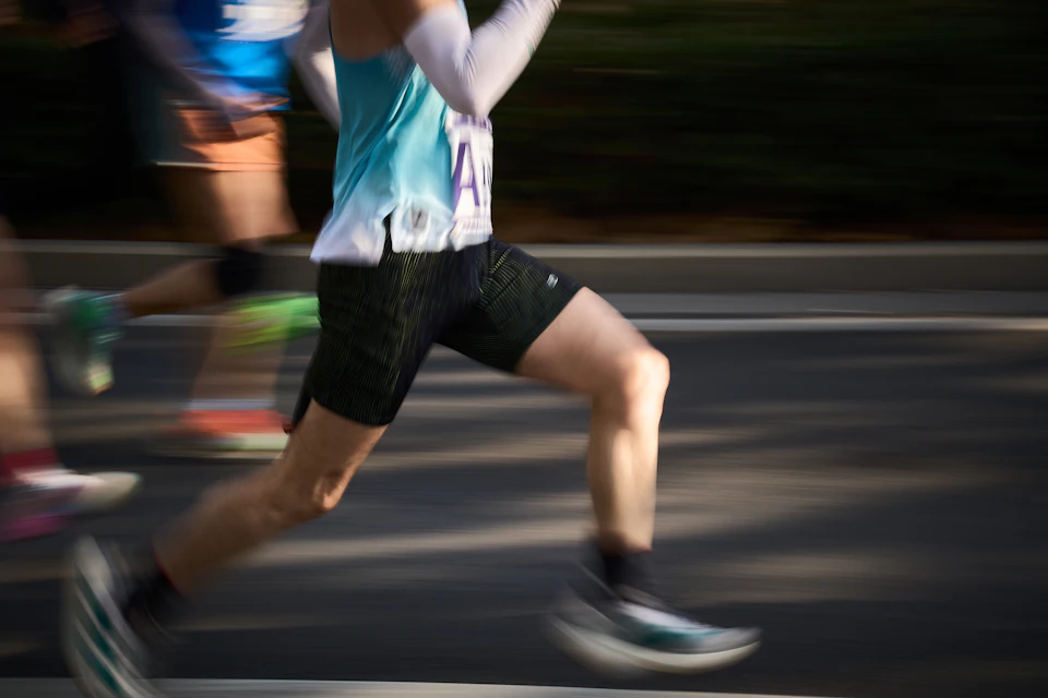 Runners in motion blur during a road race