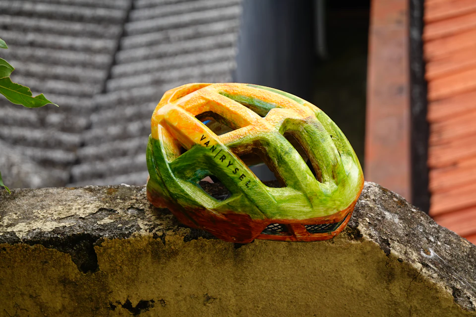 A bicycle helmet resting on a stone wall